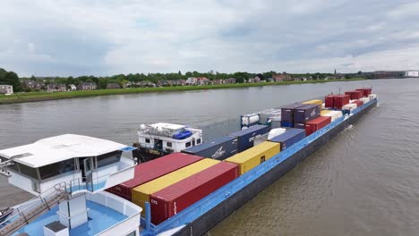 VRIDO-Cargo-Ship-Sailing-River-In-Alblasserdam,-Netherlands---Aerial-Drone-Shot