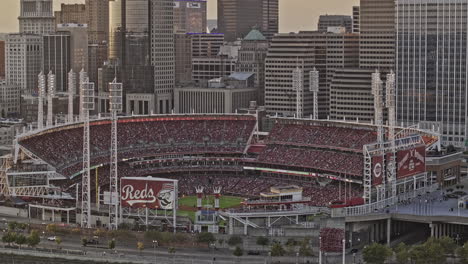 Cincinnati-Ohio-Aerial-v64-zoomed-flyover-river-capturing-baseball-game-at-Great-American-Ball-Park-against-downtown-cityscape-in-the-background-at-sunset---Shot-with-Mavic-3-Pro-Cine---September-2023