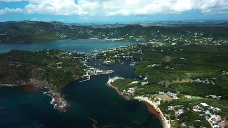 Aerial-tilt-shot-overlooking-the-the-Antigua-island,-sunny-day-in-the-Caribbean