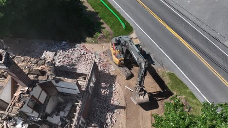 Working-excavator-demolishing-old-house