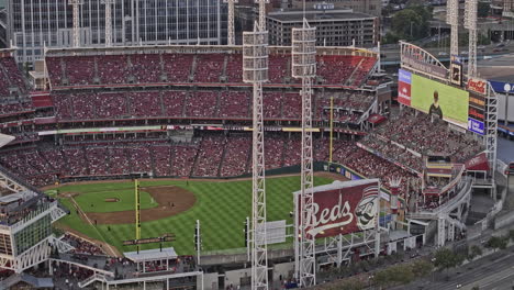 Cincinnati-Ohio-Aerial-v68-zoomed-fly-around-the-Great-American-Ball-Park-capturing-baseball-game-in-action,-cheering-crowds-and-sunset-downtown-cityscape---Shot-with-Mavic-3-Pro-Cine---September-2023