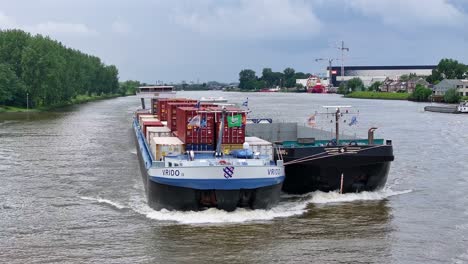 VRIDO-Ship-Navigating-River-In-Alblasserdam,-Netherlands---Aerial-Drone-Shot