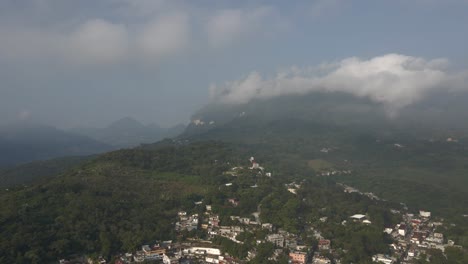 Village-in-the-deep-rainforest-jungle-central-Mexico,-aerial-nature-landscape