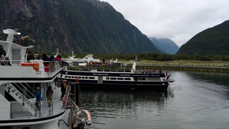 Side-view-of-Milford-Sound-Marina-with-tourist-cruise-ships-terminal-on-a-foggy-day-in-New-Zealand