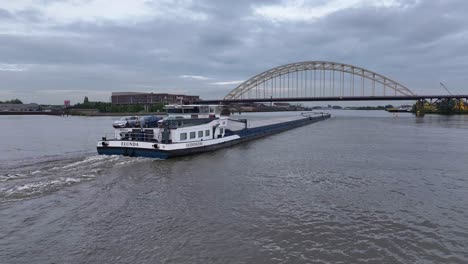 Cargo-Ship-ELUNDA-Cruising-River-In-Alblasserdam,-Netherlands---Aerial-Drone-Shot