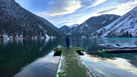 A-man-walks-on-a-pier-to-plunge-into-the-cold-water-after-a-sauna-on-a-summer-day-on-Lake-Malaren