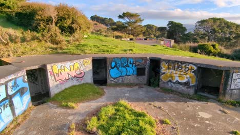 WW2-bunkers-covered-in-graffiti-located-at-The-Massey-Memorial,-Point-Halswell-in-Wellington,-New-Zealand-Aotearoa