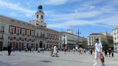 People-on-the-Puerta-del-Sol-Square-with-the-Real-Casa-de-Correos-Facade-and-Clock-Tower-in-Madrid