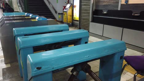 Blue-old-wooden-turnstiles-at-the-entrance-of-a-vintage-underground-subway-station-of-Buenos-Aires-,-Argentina,-line-A