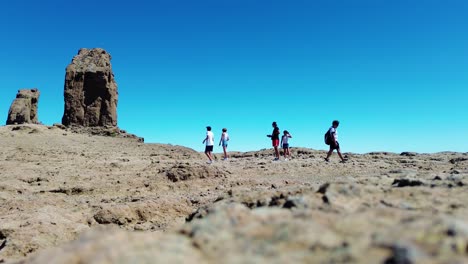 Aerial-view-of-people-hiking-in-Gran-Canaria-at-Roque-Nublo-mountain-geologic-rock-formation