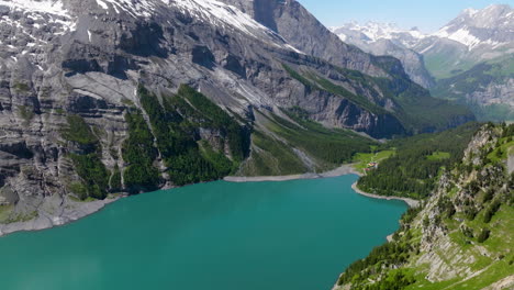 Oeschinen-Lake-With-Turquoise-Water-In-Bernese-Oberland,-Switzerland---Aerial-Shot