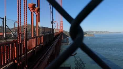 Golden-Gate-Bridge-Suicide-Deterrent-Nets-and-Traffic,-View-Behind-Fence,-San-Francisco,-California-USA