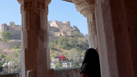 young-girl-looking-at-historic-fort-at-morning-from-flat-angle