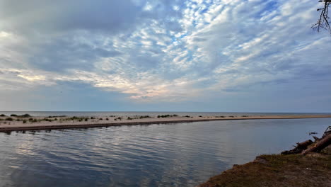 Virgin-wild-beach-at-the-Baltic-Sea-in-Latvia,-sunset-sunrise-sun-reflexion-reveal