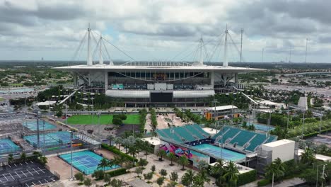 Aerial-approaching-shot-of-tennis-fields-and-famous-Hard-Rock-Stadium-of-Miami,-Florida