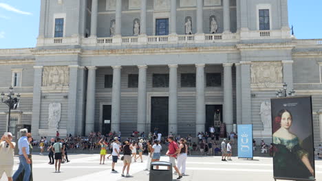 Facade-of-the-Almudena-Cathedral,-Madrid,-Tilt-Down-Revealing-Tourists