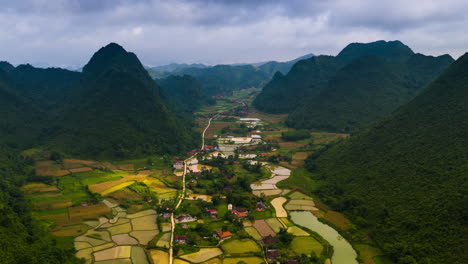 Dramatic-karst-landscape-and-flat-land-vivid-green-rice-paddies-of-Bac-Son-Valley,-Vietnam