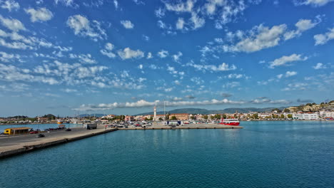 Unique-shot-revealing-the-port-of-Zakynthos-from-the-ship's-window,-wide-panoramic-view,-blue-sky