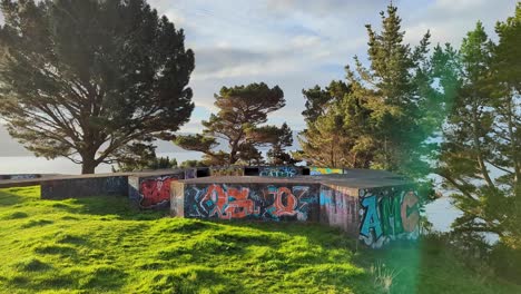 View-of-WW2-bunker-covered-in-graffiti-overlooking-harbour-at-The-Massey-Memorial,-Point-Halswell-in-Wellington,-New-Zealand-Aotearoa