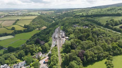 Aerial-fly-in-capturing-Okehampton-railway-station-in-Devon,-UK