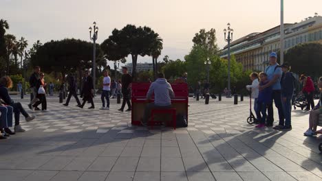 People-Watch-Talented-Man-Playing-Red-Piano-At-Place-Massena-In-Nice,-France