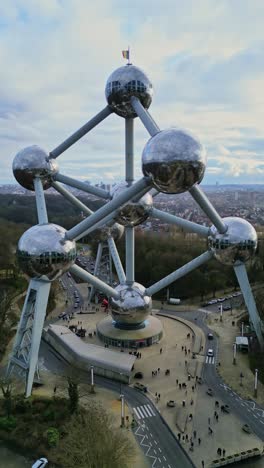 Aerial-vertical-orbit-view-of-Atomium-Bruxelles-Brussels,-Belgium-on-a-beautiful-cloudy-sky