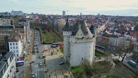 Aerial-orbit-drone-view-of-the-Porte-de-Hal-Hallepoort-in-Brussels,-Belgium-on-a-beautiful-sunset-cloudy-sky