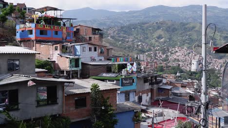 Pan-across-hillside-community-in-mountainous-Medellin,-Colombia