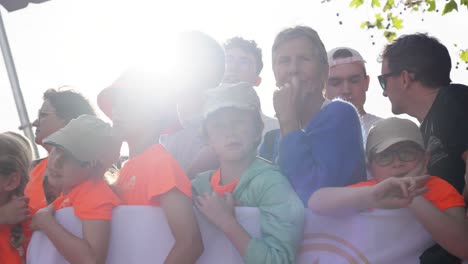 slow-motion-shot-of-children-waiting-to-see-the-Olympic-torch-relay-changing