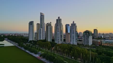 Aerial-drone-view-from-the-ecological-reserve-in-Puerto-Madero-with-a-view-of-the-buildings-and-sunset-colors-in-the-city-of-Buenos-Aires,-Argentina