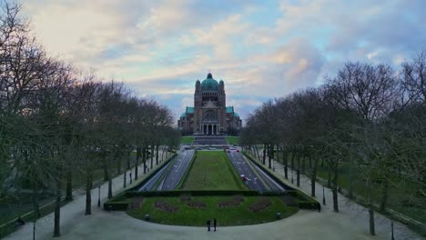 Aerial-drone-view-zoom-in-the-basilica-of-the-sacred-heart-in-Brussels,-Belgium-on-a-beautiful-sunset-cloudy-sky