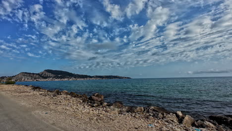 Sea-coast-of-Greece-Mediterranean-sea-water,-driving-POV-rocky-beach