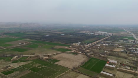 An-aerial-shot,-captured-by-drone-of-a-rural,-agricultural-landscape-in-a-remote-village-setting-located-within-Afghanistan