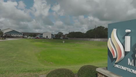 A-low-level-drone-view-zooming-out-of-the-Ignite-Medical-Resort-sign-on-Highway-3-in-Webster,-Texas