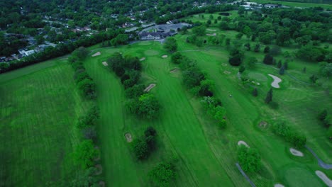 Aerial-view-of-the-golf-terrain-south-of-Chicago,-highlighting-the-expansive-green-landscape-and-the-intricate-design-of-the-course