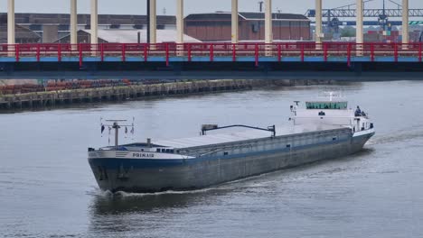 Ship-PRIMAIR-Cruising-On-River-In-Alblasserdam,-Netherlands---Aerial-Drone-Shot