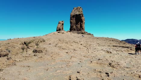 Aerial-view-of-people-hiking-in-Gran-Canaria-at-Roque-Nublo-mountain-geologic-rock-formation