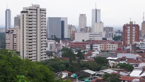 Pan-across-bustling-urban-city-skyline-cityscape-of-Cali,-Colombia