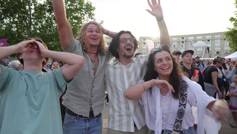 Slow-motion-shot-of-audience-members-jumping-and-smiling-at-the-Olympic-torch-relay