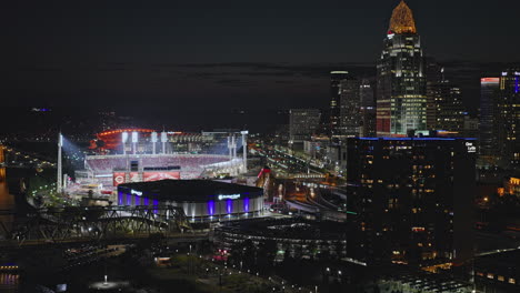 Cincinnati-Ohio-Aerial-v36-flyover-capturing-riverfront-sport-complexes,-freeway-traffic-and-bustling-downtown-cityscape-of-central-business-district-at-night---Shot-with-Inspire-3-8k---September-2023