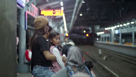 Young-local-families-awaiting-next-city-electric-locomotive-arrival