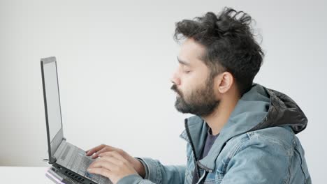 Close-Up-of-Middle-Eastern-Indian-Man-Working-on-Laptop,-Looking-Disappointed