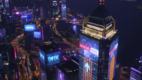 Skyscraper-and-lighting-advertising-panels-at-night-in-Hong-Kong-City-Futuristic-concept-with-motion-graphic-and-digital-animation---Information-data-communication-with-breaking-news