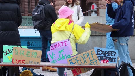 Close-slo-mo-of-girls-with-signs-at-climate-protest-rally-in-Sweden