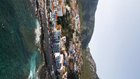 Cala-Ganone-Coastal-Town-in-Italian-Mountain-Village-on-Sardinia,-Vertical-Aerial