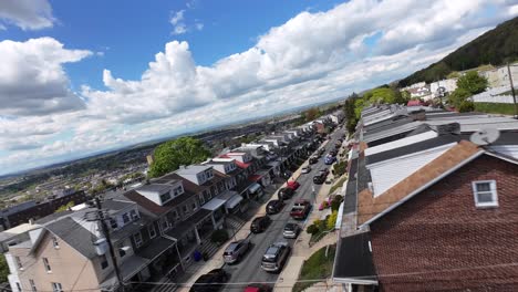 Row-of-houses-in-american-city-with-parking-cars-during-sunny-day-in-sporing