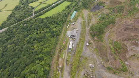 Aerial-view-of-an-old-aggregate-quarry-railway-yard-now-largely-disused-and-abandoned