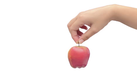 Close-up-shot-of-female-hand-spinning-a-fresh-apple-Isolated-on-clean-white-background