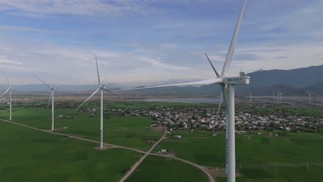 Wind-farm-in-Vietnam-flat-costal-area,-static-turbines-stationary-scattered-over-pristine-l