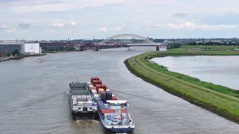 Aerial-View-Of-VRIDO-Cargo-Ship-Sailing-In-Alblasserdam,-Netherlands---Drone-Shot